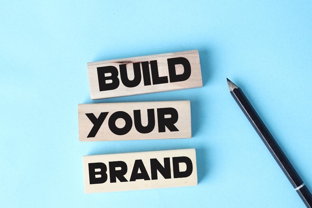 The words build your brand written on a table