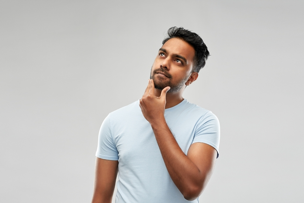 Picture of a man with his hands on the chin thinking and look up